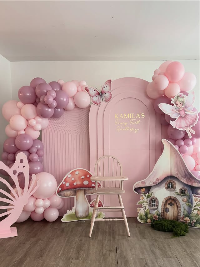 Pink fairy-themed first birthday balloon arch and backdrop